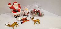 Group shot showing both Santa figurines, two reindeer, clown ornament and bag of mini ornaments