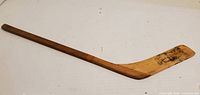 Full view of wooden mini hockey stick - handle to blade