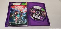 Opened "Dance Central" Xbox 360 game case showing cover insert and disc