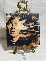 Front of sealed Robbie Robertson LP on stand showing artwork and hype sticker