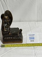 Front view showing full figure and ruler for scale