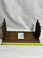 Book stand opened showing end panels and base carving