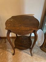 Full view of antique two-tier table showing top, legs, and shelf