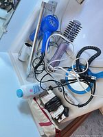 Assorted hair and grooming tools laid out on counter