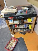 full view of rolling cart loaded with stones and tools