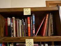 Books on shelf, assorted titles and sizes