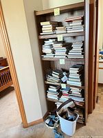 Full view of tall dark wood bookshelf with multiple shelves