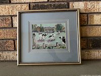 Front view of framed cow needlepoint