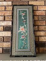 Front view of framed needlepoint tapestry showing full design and frame