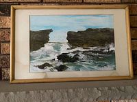 Full view of framed seascape painting showing artwork, mat and wood frame