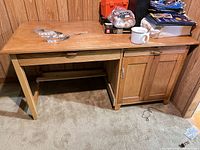 Front view of wooden computer desk with drawer and cabinet
