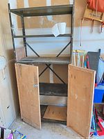 Full view of metal shelving unit, doors open showing interior shelf