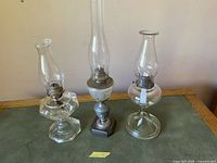 All three antique oil lamps side-by-side full view