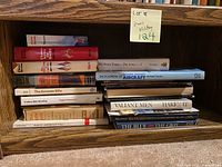 Books on shelf showing spines – titles Accurate Rifle, Position Rifle Shooting, Encyclopedia of Aircraft, Valiant Men, The Blue and the Gray etc.