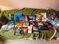 All 22 books laid out on couch showing covers and titles
