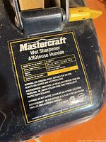 Close-up of factory label showing model, electrical ratings and warnings