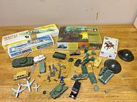Overall lot view showing boxed kits, vehicles, figures and helmets