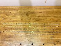 Four extended folding rulers on workbench