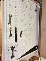 overall view of framed pegboard with hooks and hanging tools
