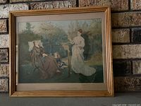 Framed color print of Victorian garden scene in wood frame