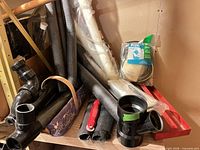 Overview of PVC pipe, insulation sleeves, ABS fittings, screen-repair kit and red tool