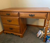 Front view of Roxton solid wood desk showing drawer configuration and legs