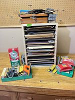 Full lot showing organizer filled with sandpaper, sanding blocks trays and steel wool