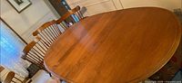 oval dining table top view with two side chairs visible