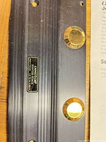 Close-up of fence body showing brass magnetic stops and Veritas badge