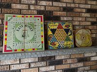 All three game boards displayed: Easy Money, Chinese Checkers, round spinner board