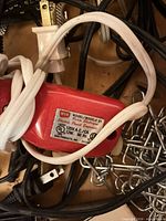 Red WEN Model 21 engraving tool with power cord, surrounding metal chain hardware