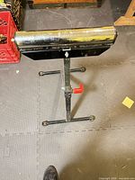 Full view of roller stand, showing roller and base