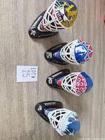 All four mini goalie masks displayed on tabletop