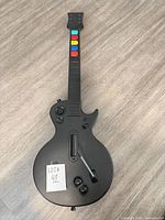 Front view of black DOYO guitar controller