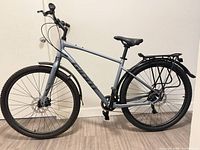 Right side view of entire Giant hybrid bicycle showing frame, wheels, disc brakes, rear rack, mudguard