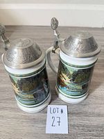 Front view showing both steins, artwork and lot identifier