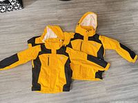 Both jackets laid flat showing overall design and colour