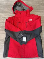 Front view of red/grey The North Face Gore-Tex jacket