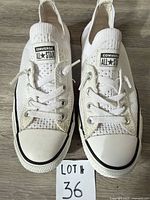 Top view of both shoes showing knit upper, laces, tongue labels, toe caps