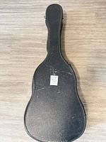 Black hard shell guitar case closed, exterior view