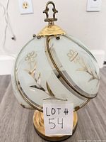 Full view of spherical floral glass touch lamp with lot tag