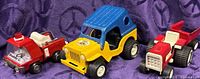 Overall view of Buddy L fire truck, Tonka Jeep and Tonka tractor with trailer