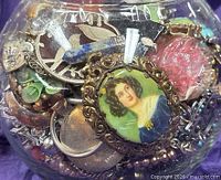 front view of glass jar packed with assorted costume jewelry