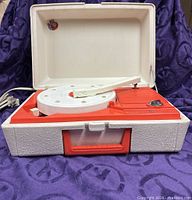 Closed-lid suitcase record player showing overall condition, handle and interior layout