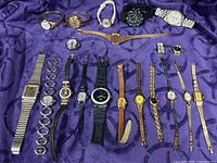 Group shot of all wristwatches on purple fabric