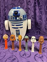 Group shot of R2-D2 projector and six PEZ dispensers