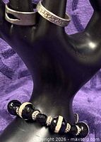 Rings and bracelet displayed on hand form