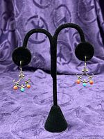 Both beaded chandelier earrings on stand displaying orange and turquoise cabochons