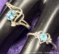 Front view of both sterling silver rings showing stone color and settings