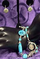 Earrings and both bracelets displayed together